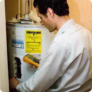 Plumber diagnoses a GE water heater before a repair