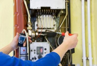 Ethan is checking the connections on a furnace